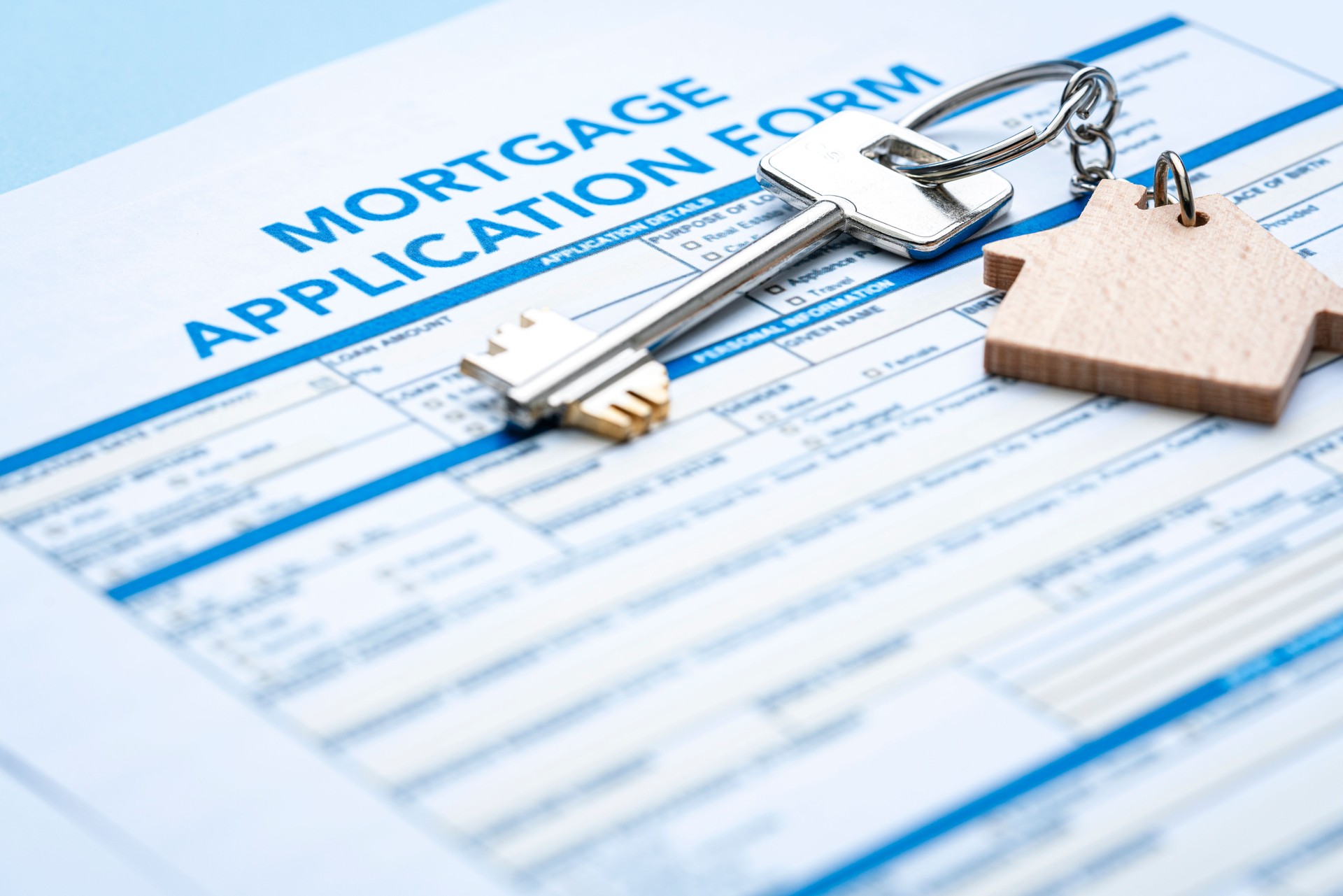 House key on mortgage application form. Mortgage loan concept