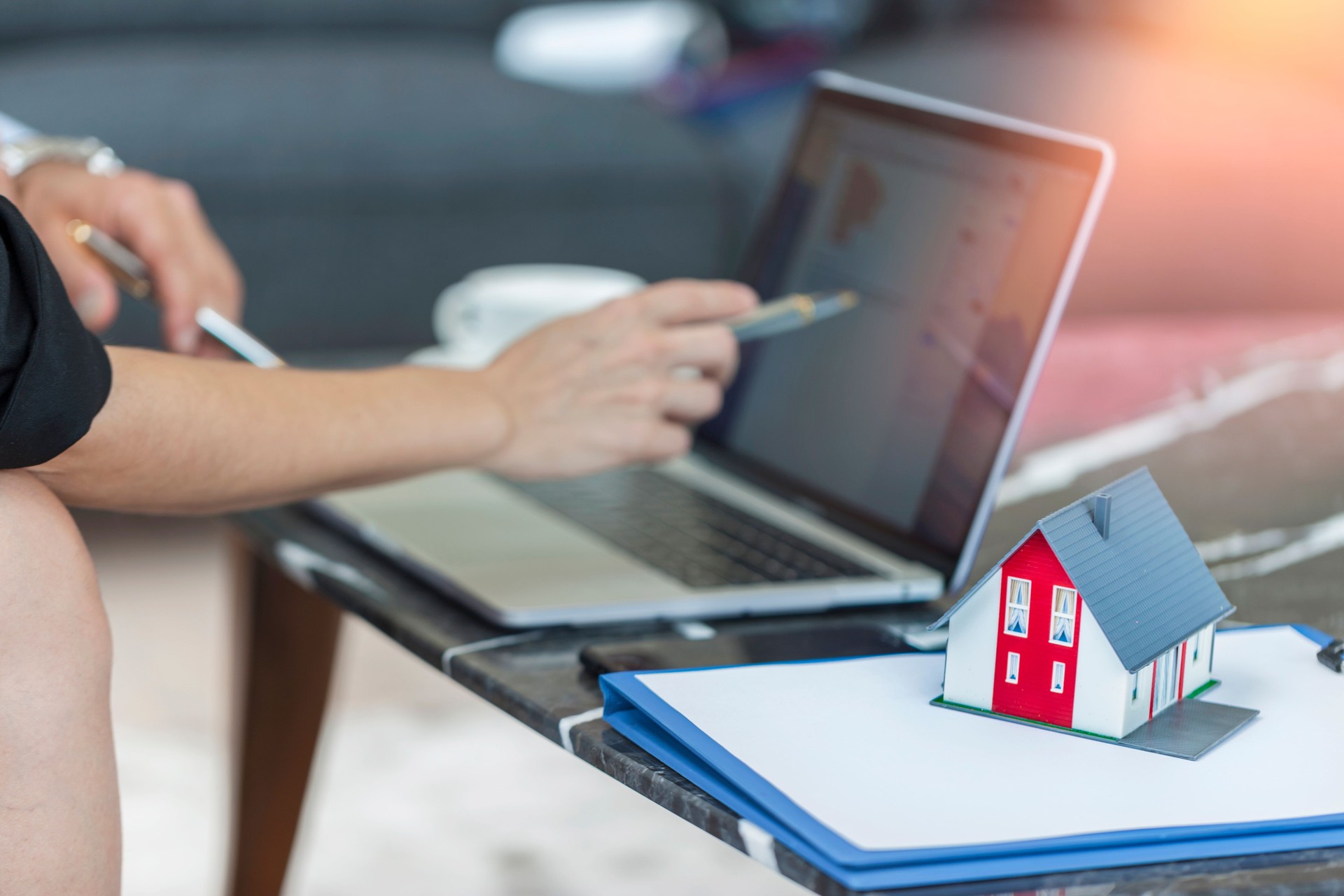 Close up of unrecognizable real estate agent using laptop in the office