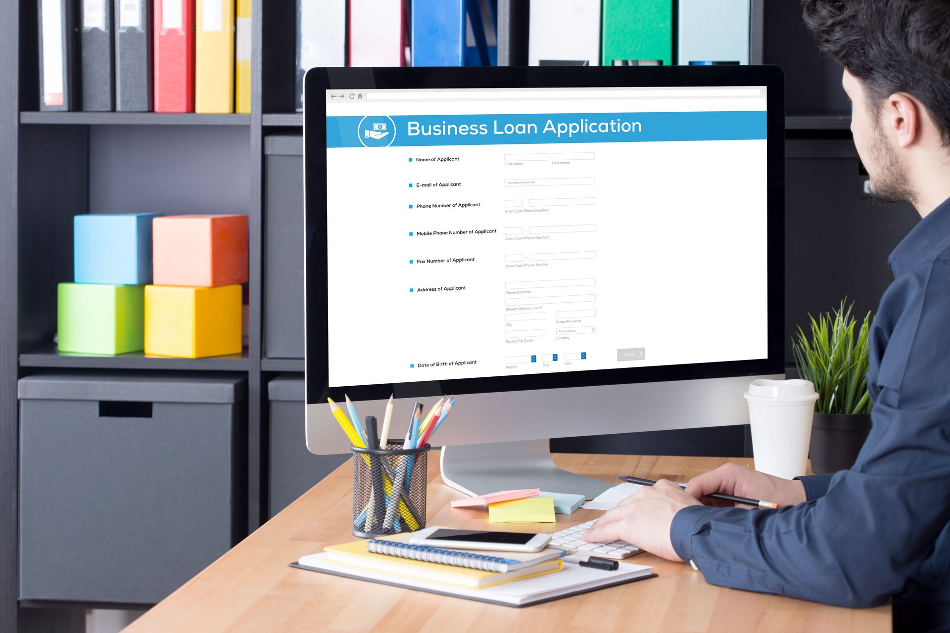 Businessman filling Business Loan Application form on Internet