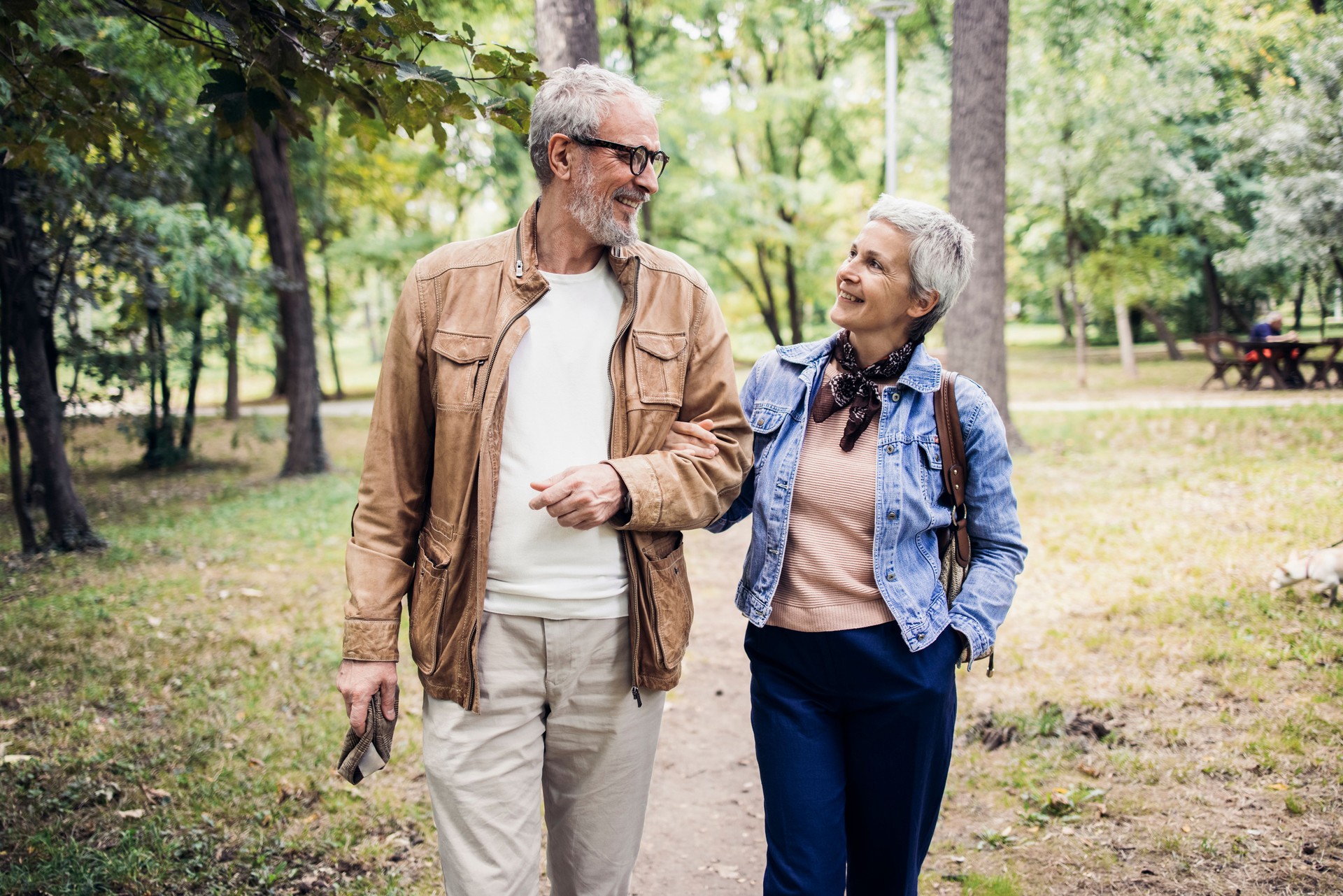 Happy senior couple enjoying their walk in the park